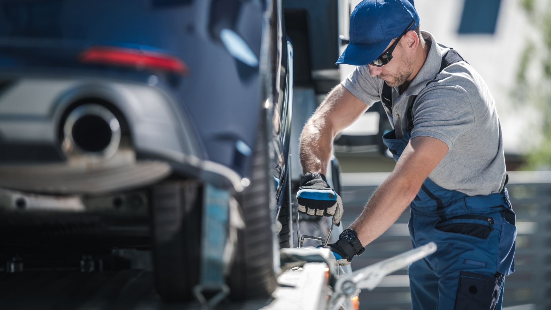 Automotive technician checking car tire pressure in service center